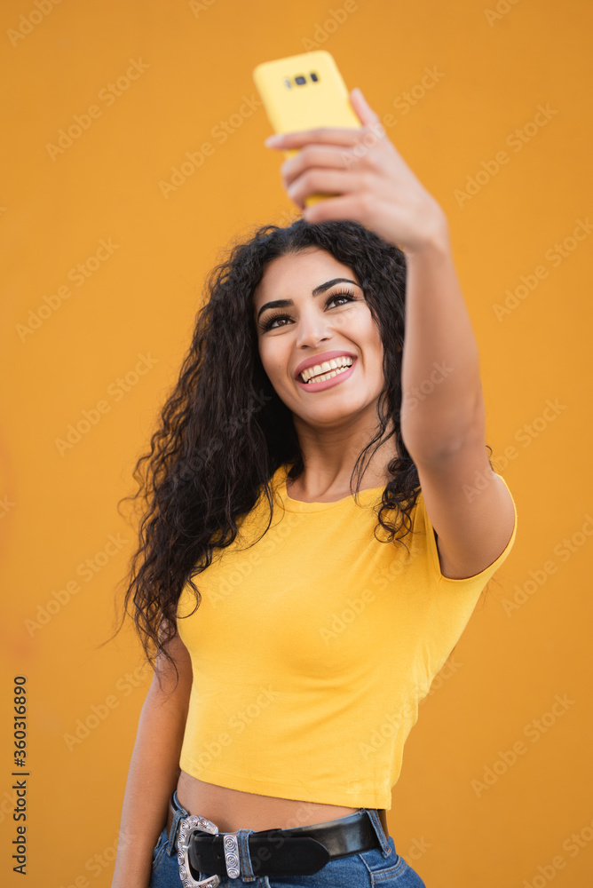 Funny mixed race girl taking selfies pictures with her smartphone Funny mixed race girl taking selfies pictures with her smartphone