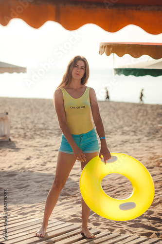 young slim beautiful woman, sexy model by the sea on the beach, playful, dancing, running, indie style, summer vacation, sunny, having fun, positive mood, romantic, happy