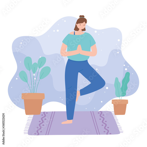 woman practicing yoga vrksasana pose exercises, healthy lifestyle, physical and spiritual practice