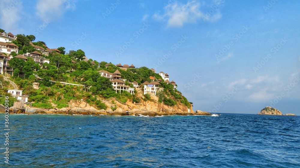 Holiday homes on the cliff of Thailand island. Blue ocean and sky. Isolated vacation. Holiday homes on the cliff of Thailand island. Blue ocean and sky. Isolated vacation.