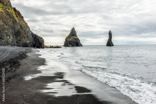 Iceland, Vik village, Reynisfjara  Black sand beach and ripple capes in Atlantic Ocean. Famous travel destination on Golden Circle touristic route. Beautiful Icelandic landscape.