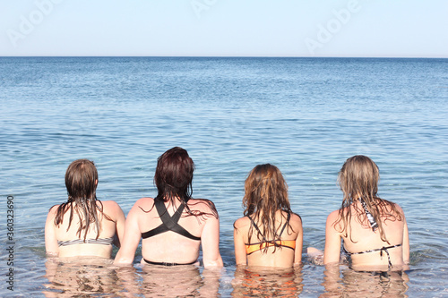 4 girls in bikini relaxing on seaside. Vcation photos. photo