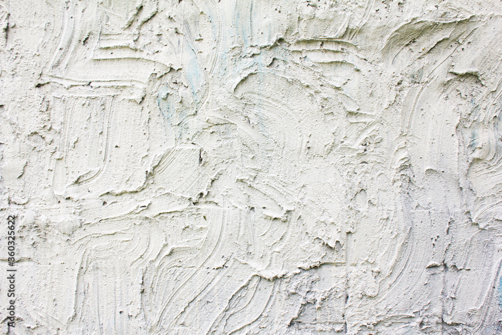 Obraz premium White rough stucco plaster strokes on a wall texture background.
