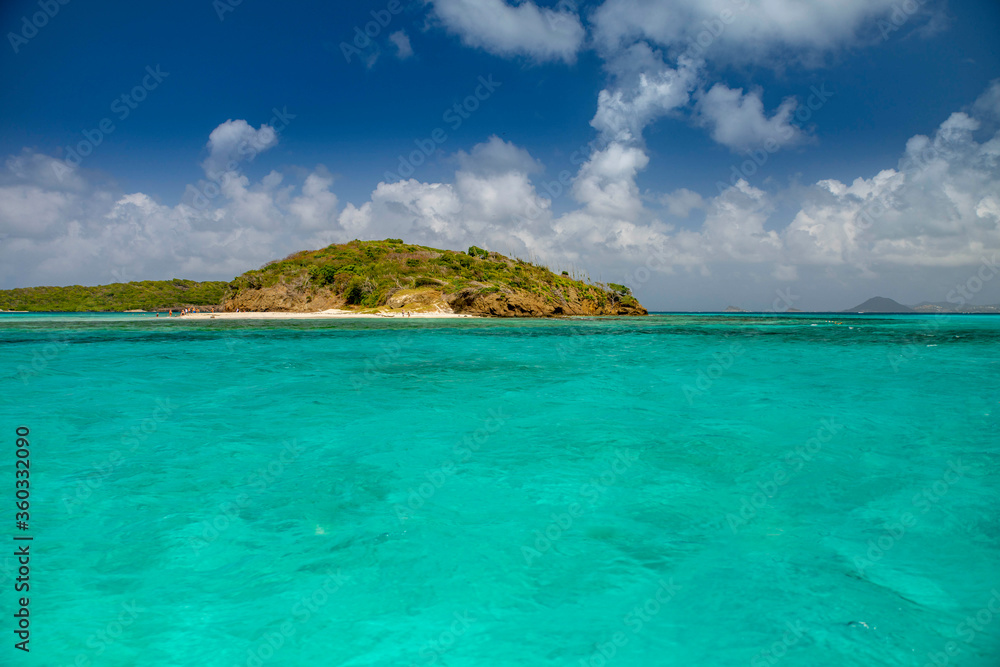 Seascape with turquoise blue water and sky with puffy clouds, islands in the Caribbean Ocean Seascape with turquoise blue water and sky with puffy clouds, islands in the Caribbean Ocean