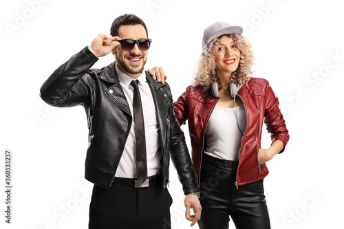 Young man with sunglasses with a young woman both wearing leather jackets © Ljupco Smokovski