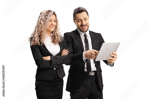 Professional man in a black suit showing something on a tablet to a businesswoman