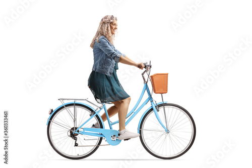 Young woman riding a blue city bicycle © Ljupco Smokovski