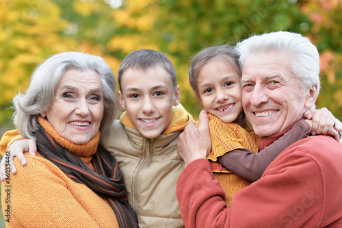 Happy grandfather, grandmother and grandchildren in park