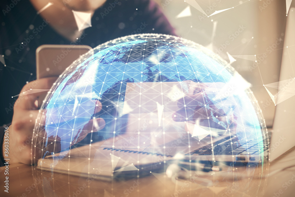 Double exposure of man's hands holding and using a phone and international business theme drawing. Double exposure of man's hands holding and using a phone and international business theme drawing.