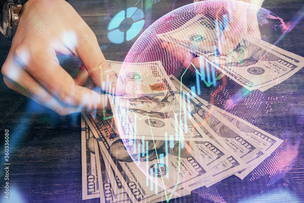 Multi exposure of financial graph drawing hologram and USA dollars bills and man hands. Analysis concept. Multi exposure of financial graph drawing hologram and USA dollars bills and man hands. Analysis concept.