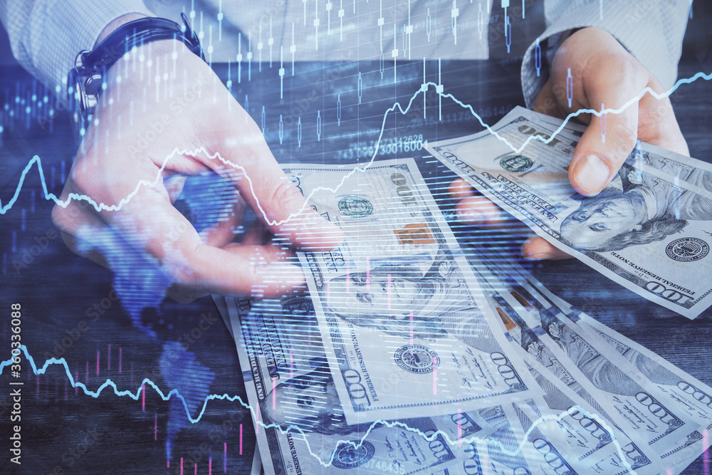 Multi exposure of financial graph drawing hologram and USA dollars bills and man hands. Analysis concept. Multi exposure of financial graph drawing hologram and USA dollars bills and man hands. Analysis concept.