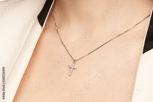 Woman's decollete with a luxury jewelry. Unusual and elegant pendant.