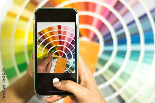 The designer photographs the color palette. Catalog of rainbow color samples.
