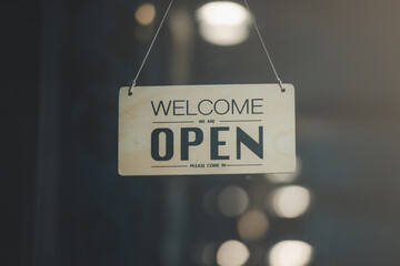 "Open" on cafe or restaurant hang on door at entrance.