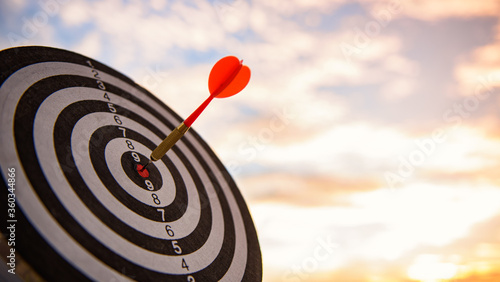 business marketing as concept. Red dart arrow hitting in the target center of dartboard Target hit in the center.