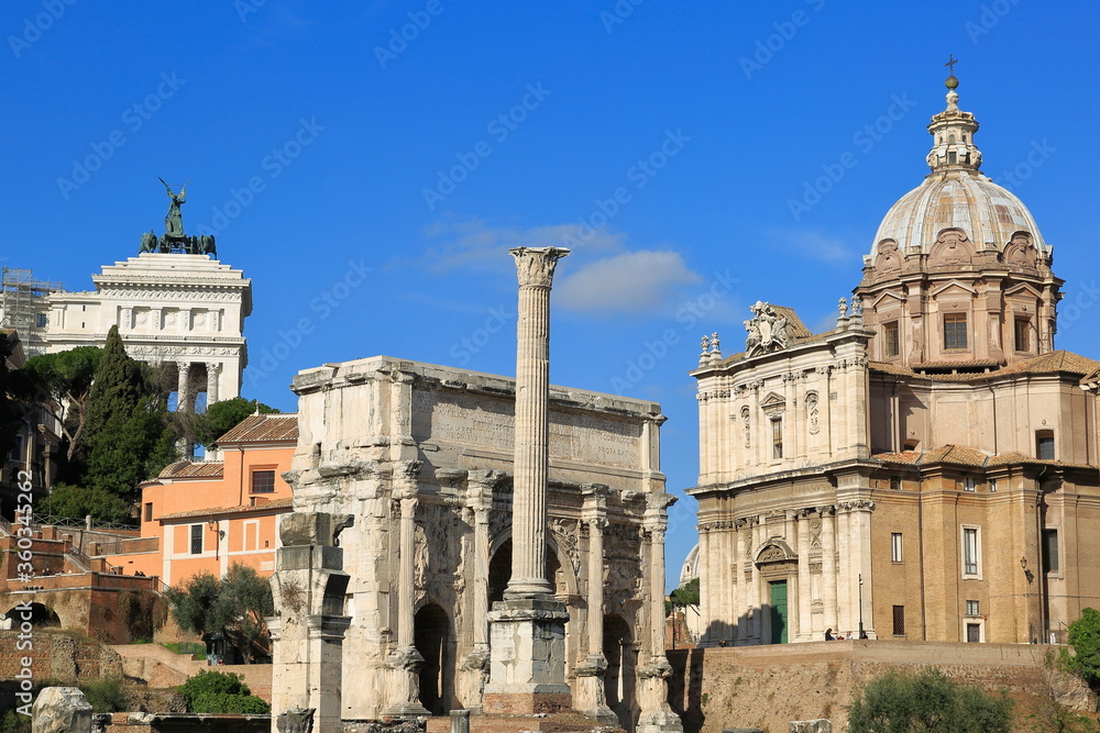 Ancient Roman ruins and distant church dome. Italy. A view from the Old Roman Forum. Rome, Italy