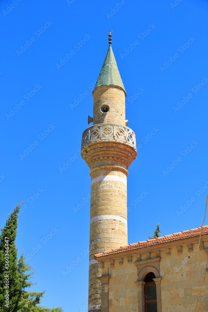 An ancient minaret in Anatolia. View of traditional and small old mosque.