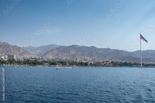 Coastal town in Jordan, distant view from a boat  photo