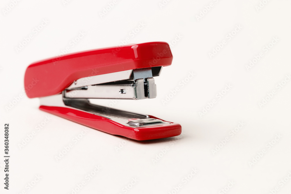 Red stapler on a white background. Red stapler on a white background.