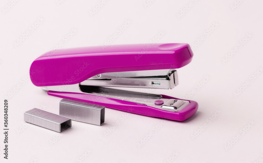 Pink stapler on a white background. Pink stapler on a white background.