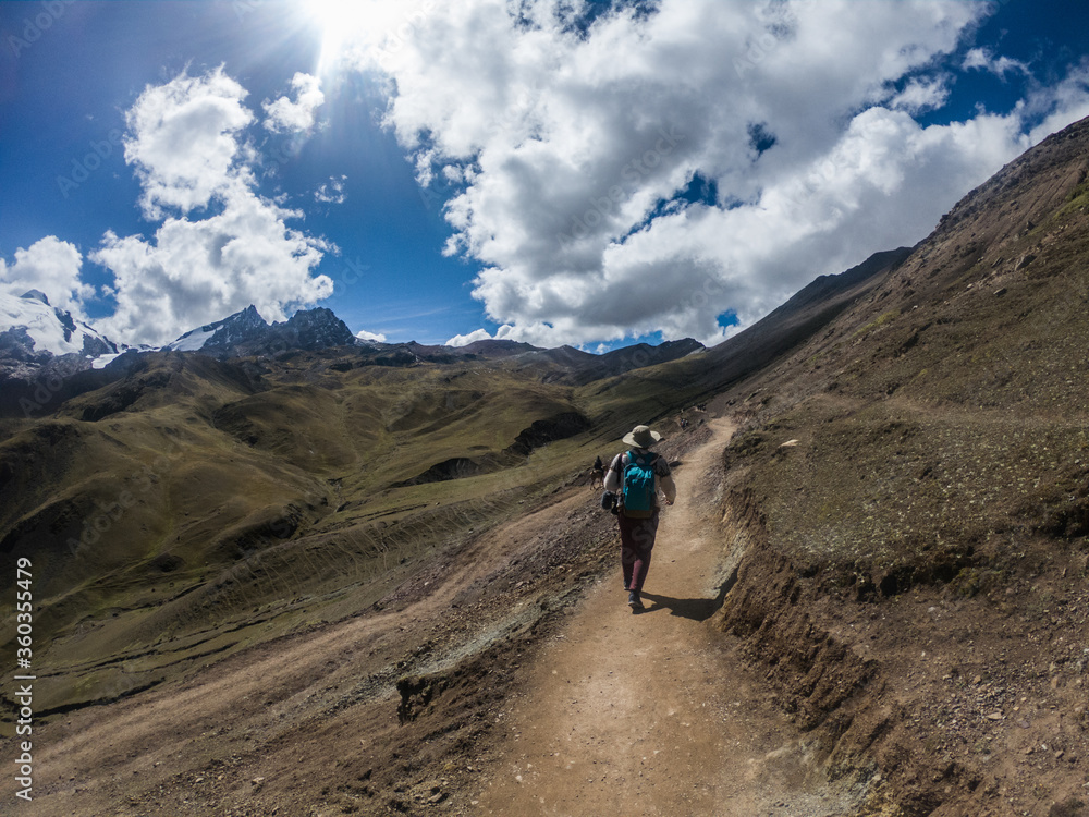 young man walking in a road in the mountains young man walking in a road in the mountains
