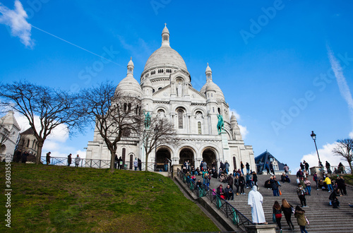 фотография Tourists visiting the Sacre Coeur Basilica at the Montmartre hill in Paris Franc