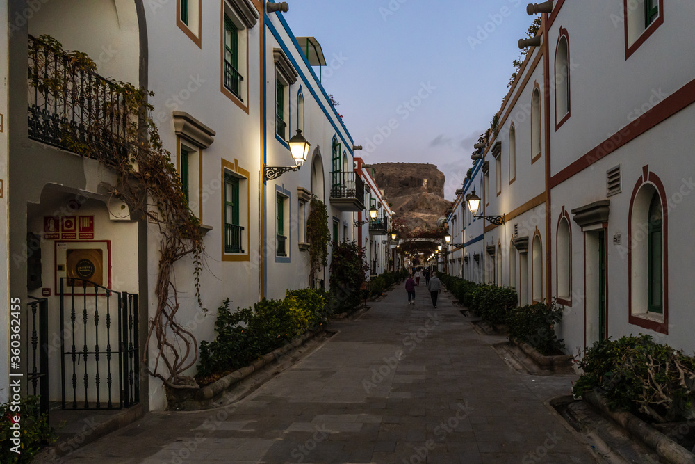 narrow street at evening in the old town of puerto mogan, gran canaria, spain