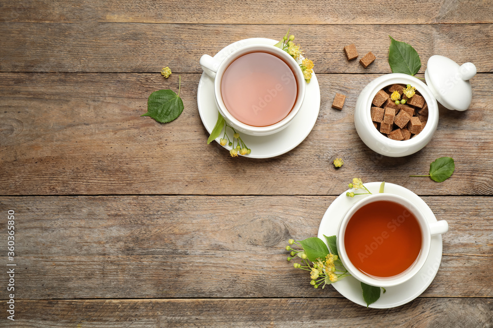 Flat lay composition with tea and linden blossom on wooden table. Space for text Flat lay composition with tea and linden blossom on wooden table. Space for text
