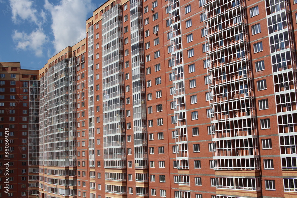 modern multi-storey brick residential building with Windows on the facade modern multi-storey brick residential building with Windows on the facade