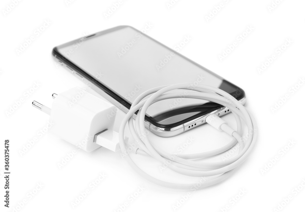 Smartphone and USB charger on white background. Modern technology Smartphone and USB charger on white background. Modern technology