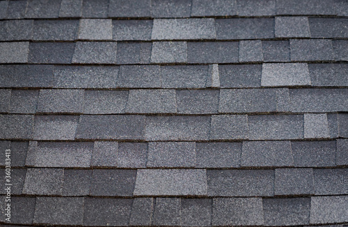 A pattern created by asphalt shingles on a roof.   photo