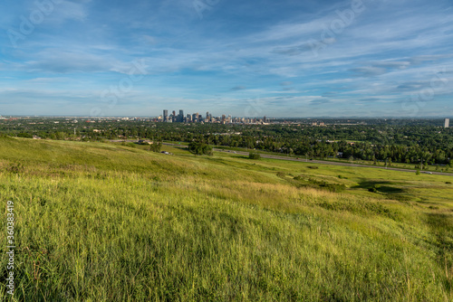 View of Calgary and its downtown skyline from Nose Hill Park during the evening. 