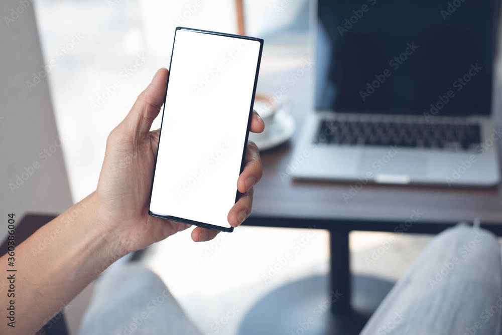 Mockup of man using blank screen mobile phone working in coffee shop Mockup of man using blank screen mobile phone working in coffee shop