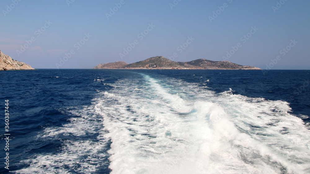 Ship wake with Symi island on the horizon, Greece