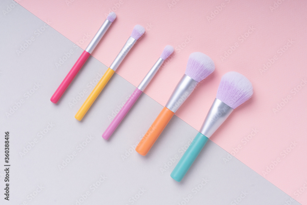 Top view - Rainbow pastel colourful brushes over bright colour background. Top view - Rainbow pastel colourful brushes over bright colour background.
