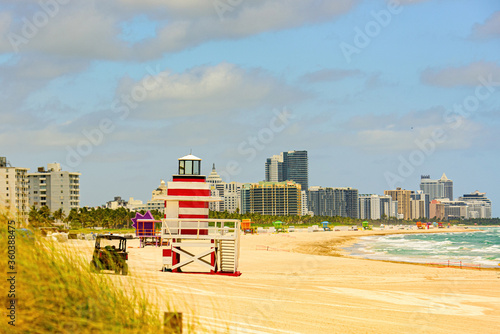 Miami Beach with lifeguard tower and coastline with colorful cloud and blue sky. Lifeguard Post on Miami Beach. Sandy Tropical Scene. © Volodymyr