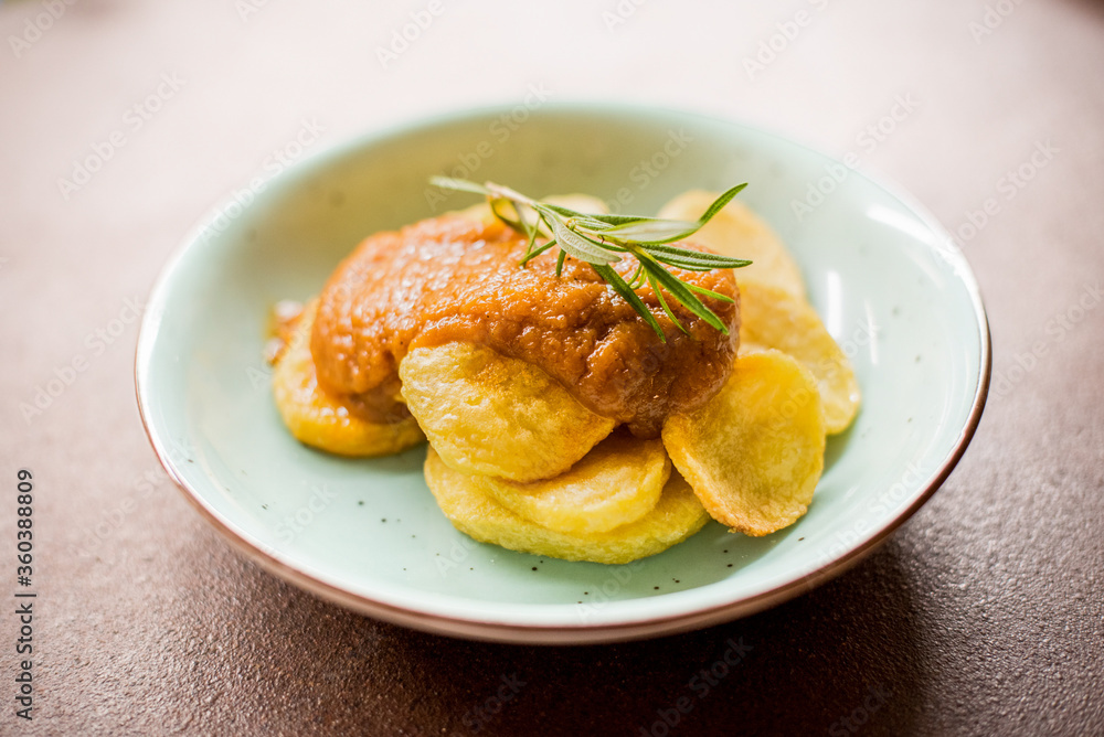 Potato dish with sauce on a white background Potato dish with sauce on a white background