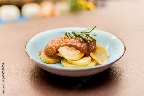 Potato dish with sauce on a white background
