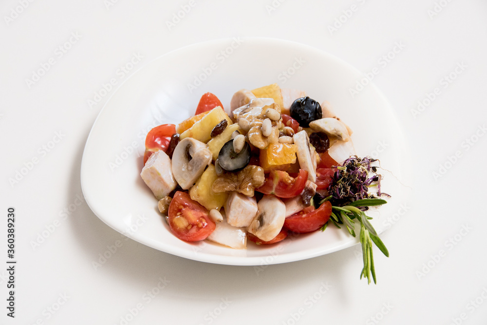 A plate of tomato and cheese salad on a white background A plate of tomato and cheese salad on a white background