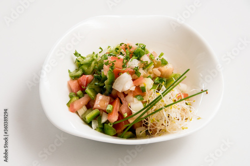 A plate of tomato and cheese salad on a white background