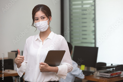 Confident business asian woman stand and wear masks with New nomal.