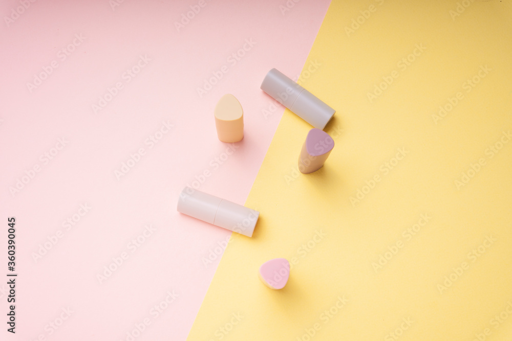 Flat lay fashion set - Brown pink lipstick and brush for powder on pastel background. Flat lay fashion set - Brown pink lipstick and brush for powder on pastel background.