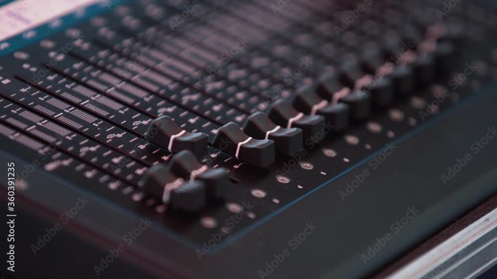 Soundboard mixer with close up faders indoors in slow motion Soundboard mixer with close up faders indoors in slow motion