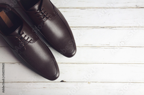 Men's formal leather Shoes isolated on wooden table  © V.R.Murralinath