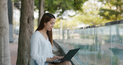 Canvas Print Woman works on laptop computer outdoors