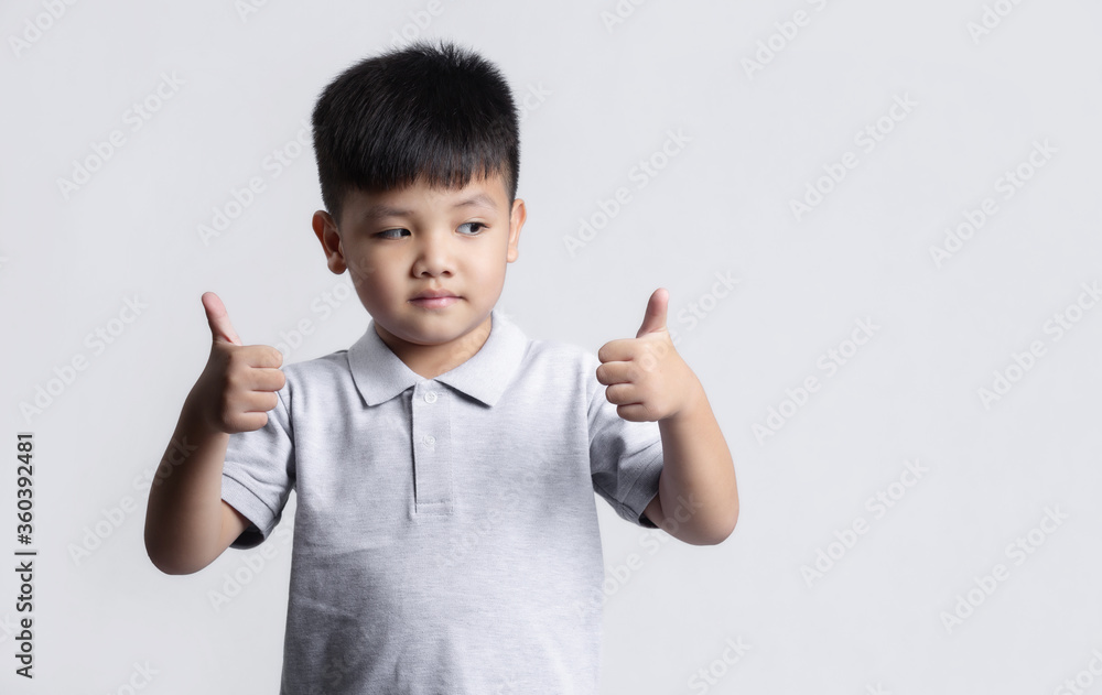 Cute little child having fun. studio portrait on gray background