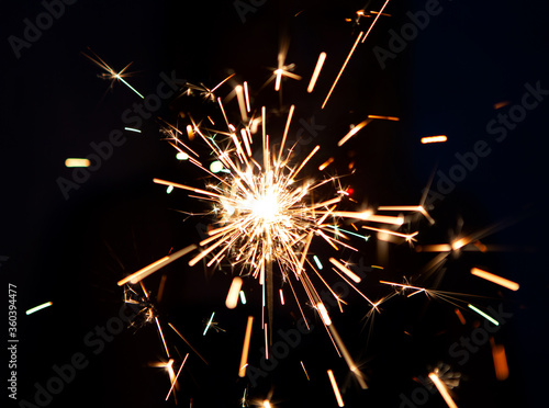 Wallpaper Mural Lighting a Firework Sparkler In Celebration of the Holidays Crackling in the Dark Torontodigital.ca