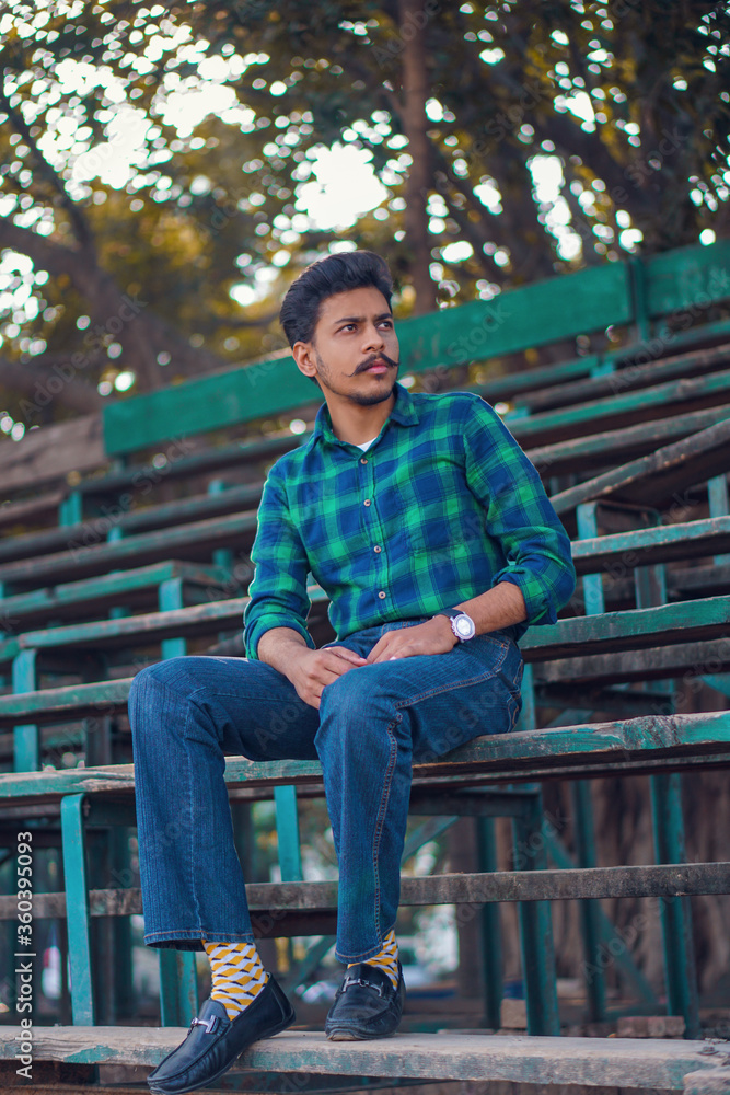 Fototapeta premium young man sitting on a bench