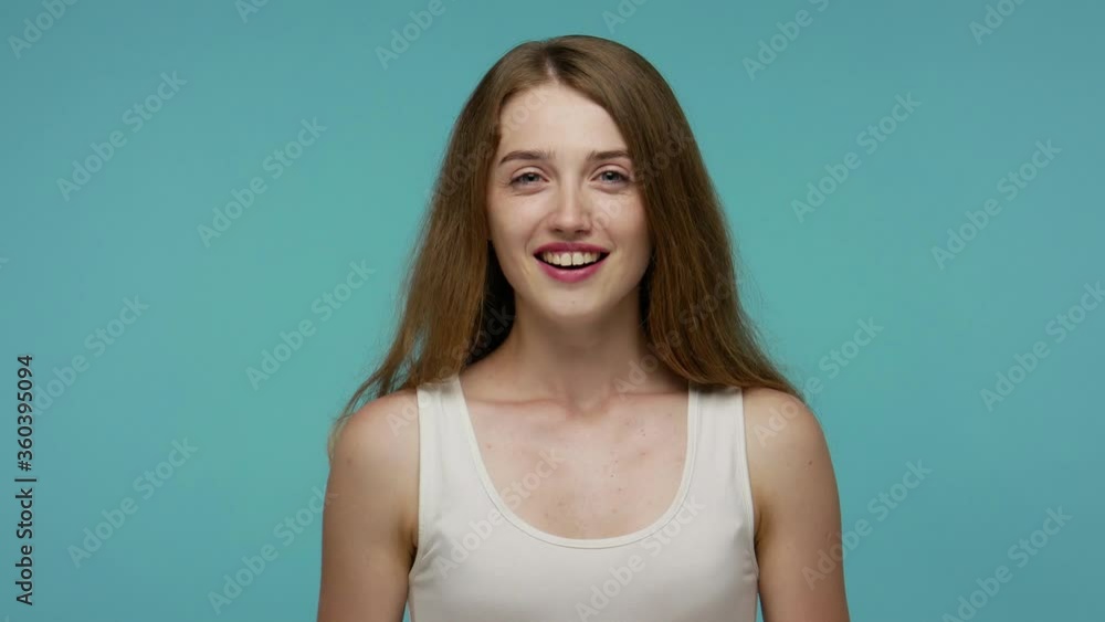 Positive lovely girl smiling and watching something unbelievable, opening her mouth in amazement, looking surprised at camera, disbelief reaction on face. studio shot isolated on blue background Positive lovely girl smiling and watching something unbelievable, opening her mouth in amazement, looking surprised at camera, disbelief reaction on face. studio shot isolated on blue background