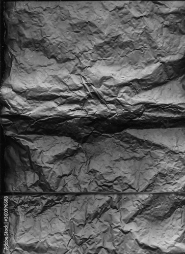 Black grunge background. Concrete wall texture. Aged wrinkled paper structure.